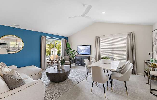 A living room with a blue wall and a television.