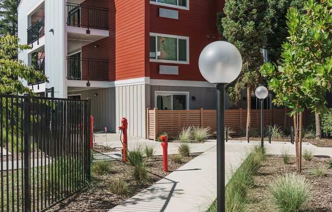 a red and white building with a sidewalk in front of it