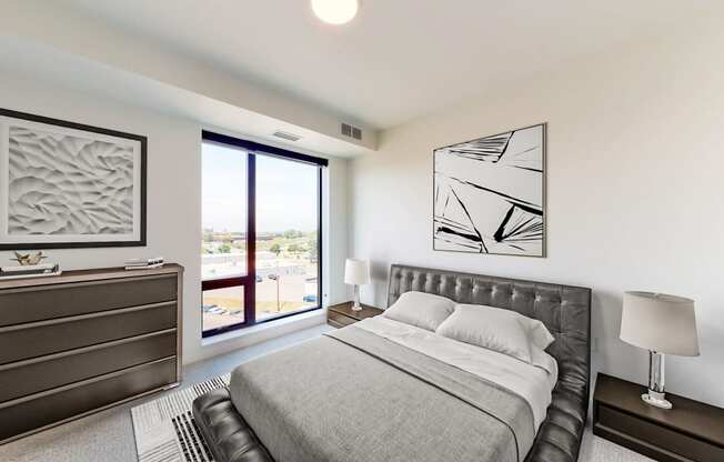 a bedroom with a bed and a large window