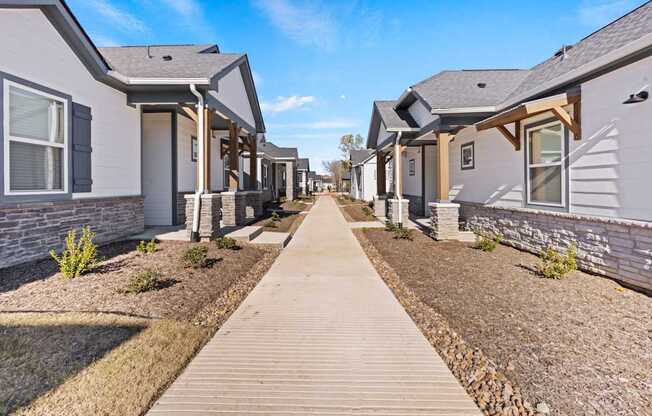 A row of houses with a wooden walkway in the foreground.