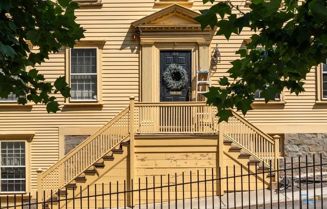 A house with a front porch and a wreath on the door.