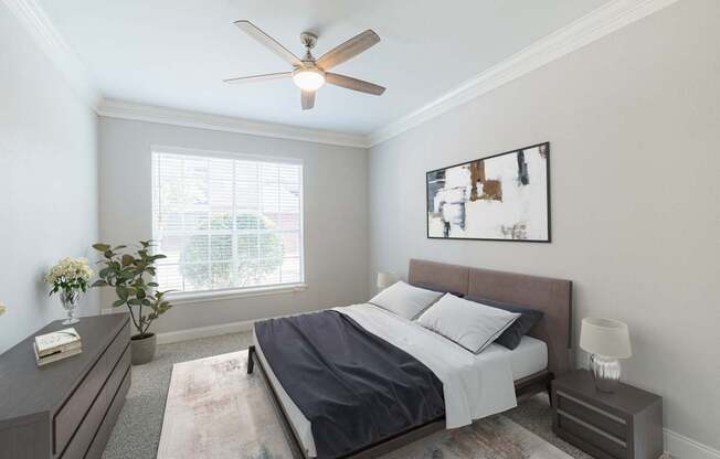 a bedroom with a bed and a ceiling fan