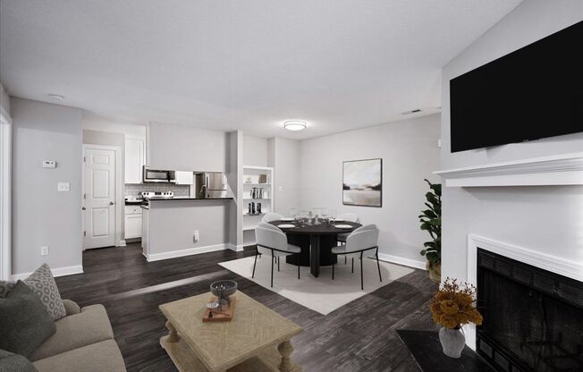 a living room with a table and chairs and a fireplace