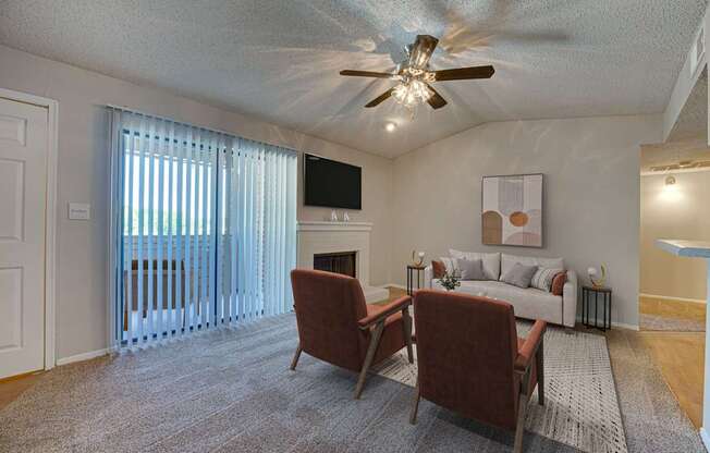 A living room with a fireplace and a television.