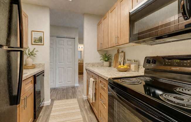A kitchen with black appliances and wooden cabinets.