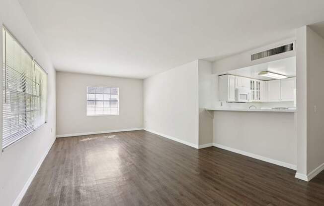 A room with wooden flooring and a window.