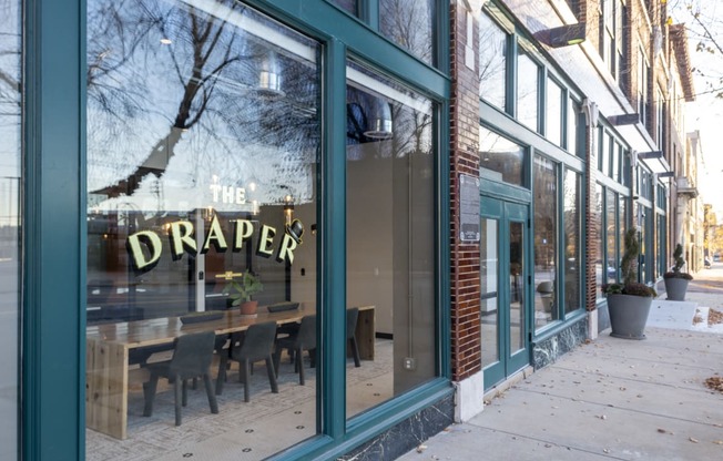 a restaurant with a large window with the drapery cafe sign in it at The Draper, St Louis, MO