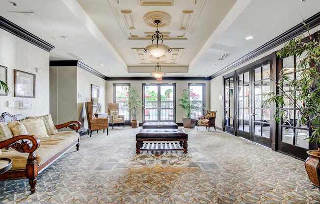 A living room with a couch, coffee table, and a chandelier.