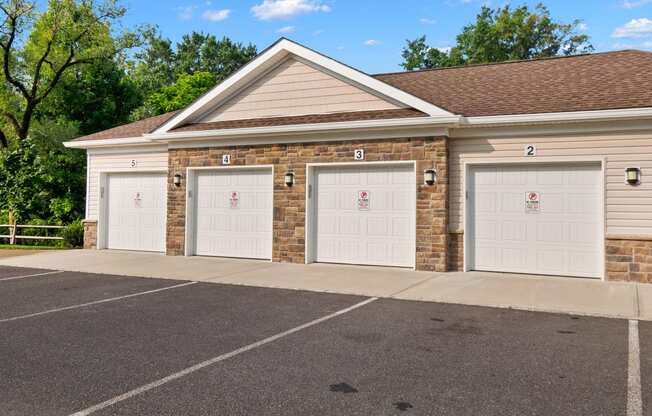 the front of a brick building with three garage doors
