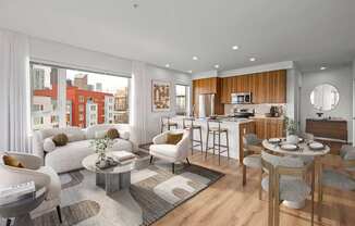 A modern living room with a kitchen area in the background.