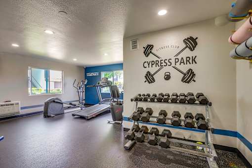 A gym with a sign that says Cypress Park Fitness Club.