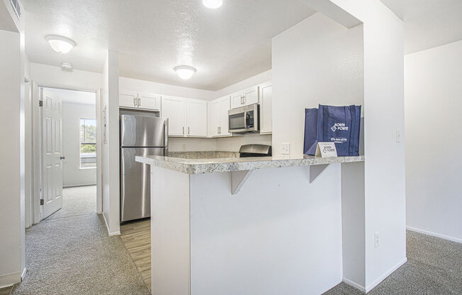 a kitchen with a breakfast bar at North Pointe Apartments in Elkhart, IN