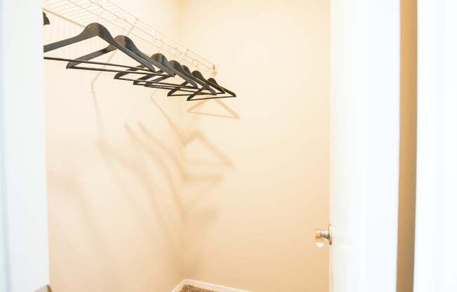 a closet with some clothes hangers on the wall