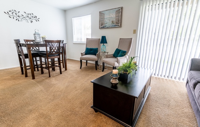 an open living room and dining room with a table and chairs