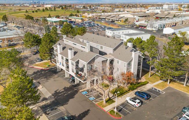 A parking lot in front of a large building.