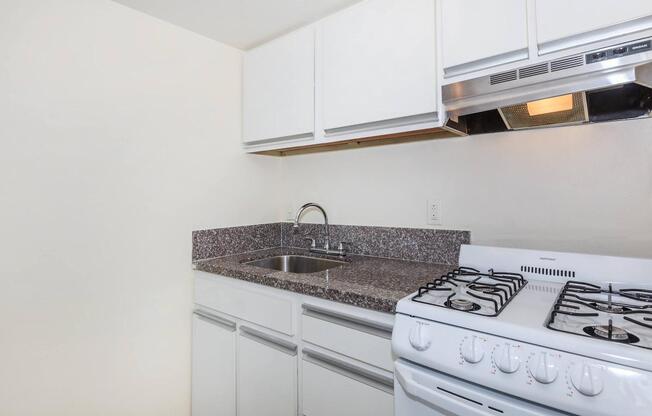 a stove top oven sitting inside of a kitchen