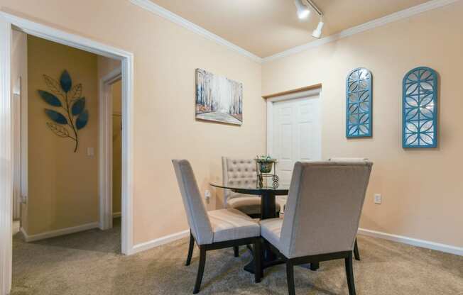 a dining room with a table and chairs