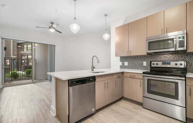 A modern kitchen with a stainless steel dishwasher and oven.