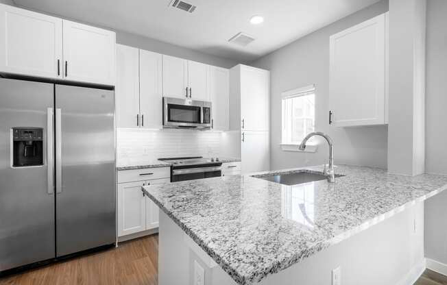 a kitchen with granite counter tops and stainless steel appliances