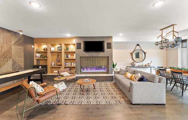A modern living room with a fireplace and a television.