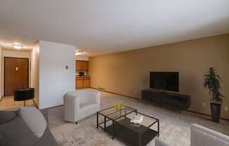 a living room with a couch and a coffee table. Fargo, ND West Oak Apartments