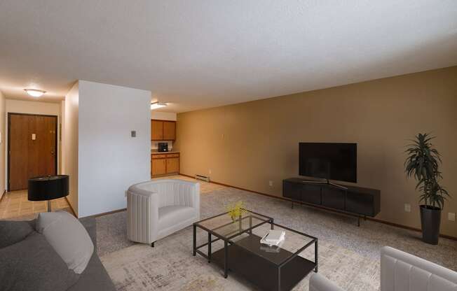 a living room with a couch and a coffee table. Fargo, ND West Oak Apartments