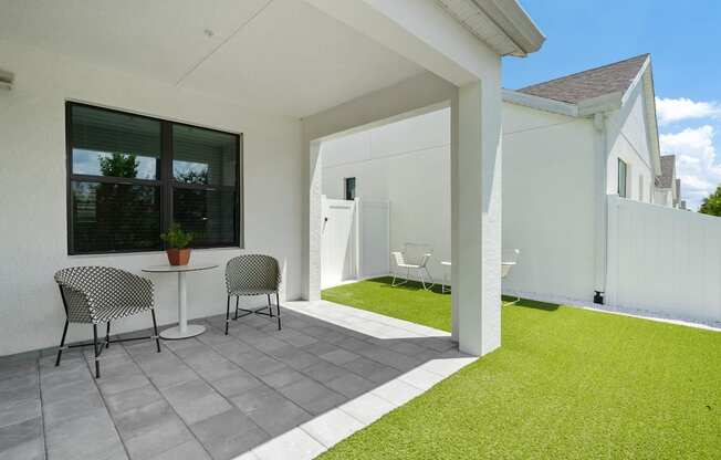 a patio with two chairs and a table on a patio at Odyssey, Fort Myers, FL, 33905
