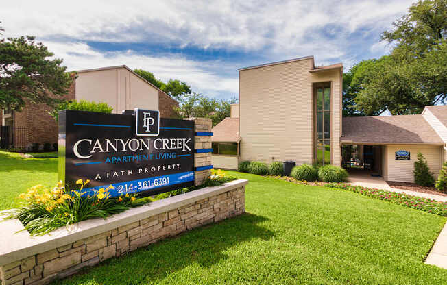 A sign for Canyon Creek Apartments at Canyon Creek Apartments Apartments in the Dallas Midtown neighborhood of Dallas, TX.