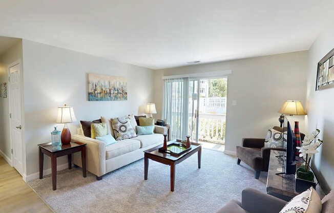 A living room with a couch, a coffee table, and a painting on the wall.