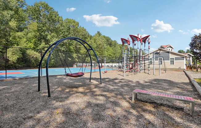 A playground with a swing set and a slide.