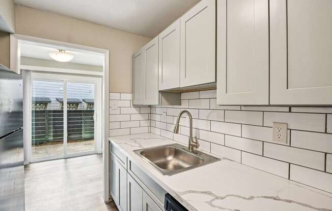 A kitchen with a sink and cabinets.