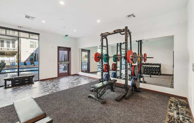 a gym with weights and dumbbells in the corner of a room at Link Apartments® Broad Ave, Tennessee