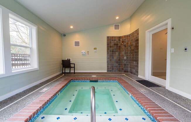 A small indoor swimming pool with a tiled edge.