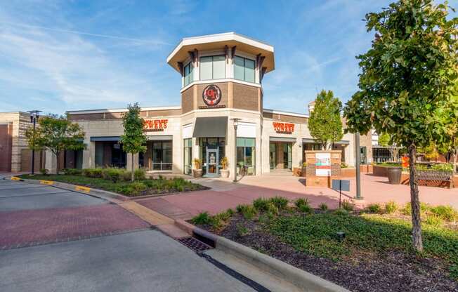 the exterior of a store with a clock on the front of it