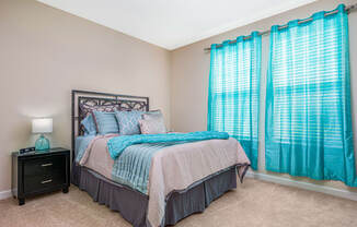 Bedroom with cozy bed with curtains at The Oasis at Crosstown, Orlando