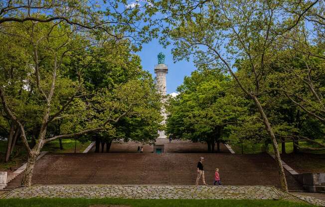 a man and two children standing on a wall in front of a lighthouse at The Paxton, Brooklyn, New York