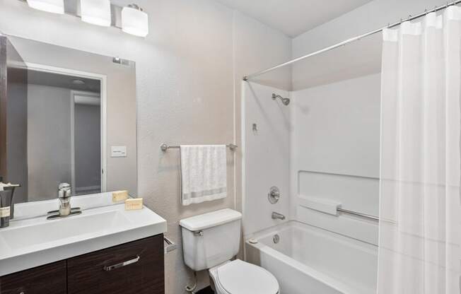 a bathroom with a toilet sink and bathtub