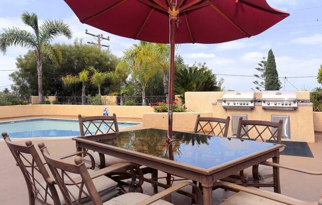 a patio with a table and chairs and an umbrella