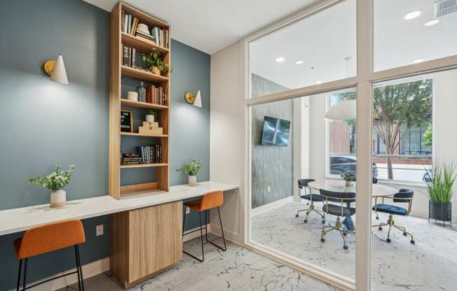 a home office with a desk and a large window