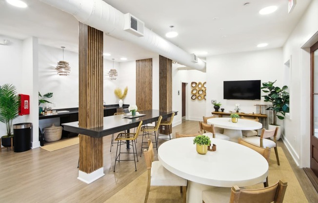 a living room with tables and chairs and a television