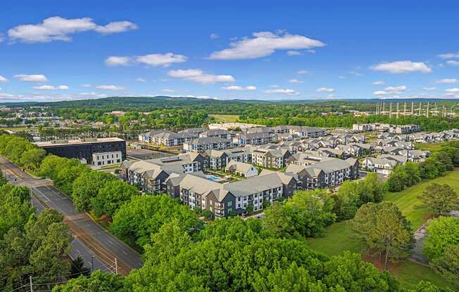 an aerial view of a city with houses and trees