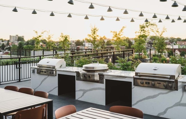 The rooftop at Modera Broadway beckons with string lighting and grilling stations perfect for gathering outdoors