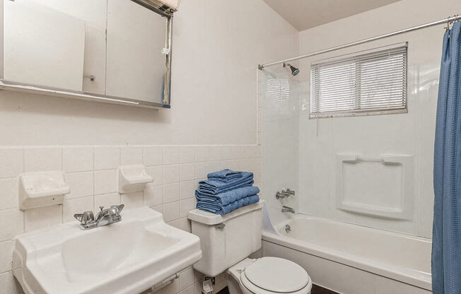 a bathroom with a sink toilet and a tub