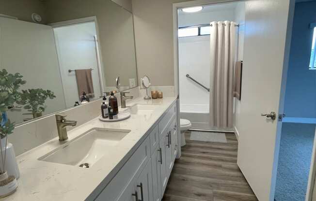 a bathroom with white cabinets and a sink and a mirror