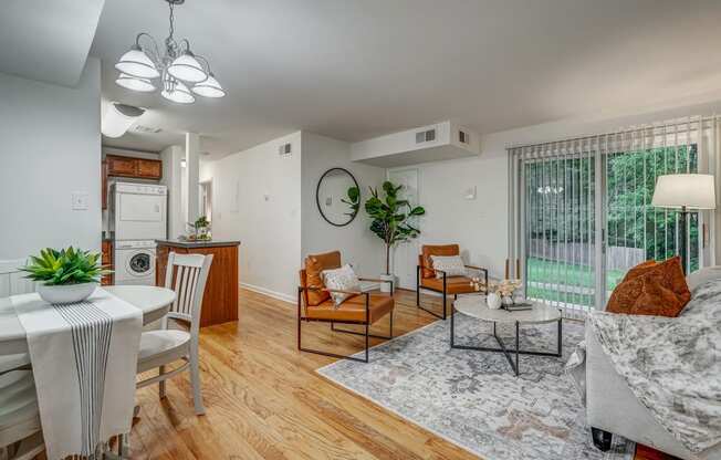 an open living room with a kitchen and a sliding glass door