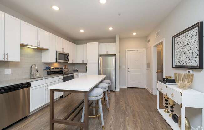 A kitchen with a table and chairs in the middle of the room.