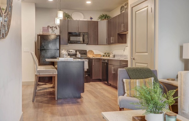 a kitchen and living room with a refrigerator and a table