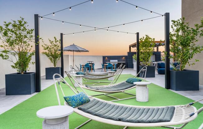 Rooftop deck seating at Modera Pomona offers stunning views, cozy vibes, and the perfect spot to unwind or entertain.