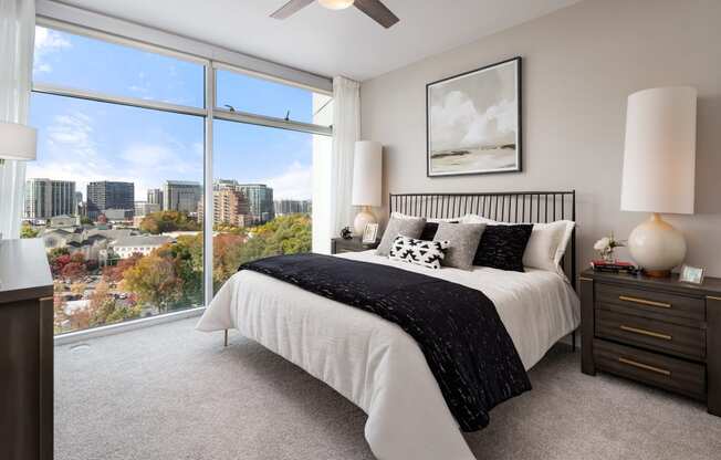 a bedroom with a bed and a view of the city