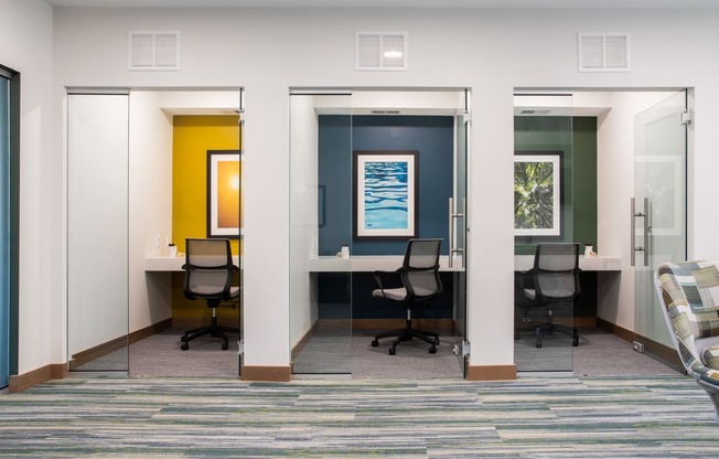 A room with three doors and a carpeted floor.